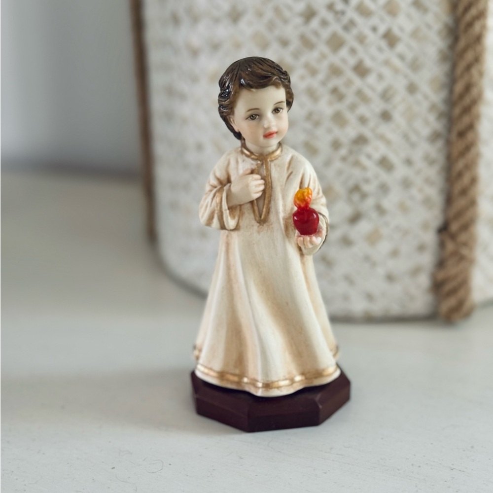 Divine Child figurine holding heart